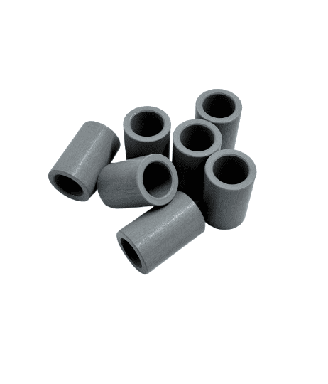 A group of small, cylindrical gray rubber stoppers.