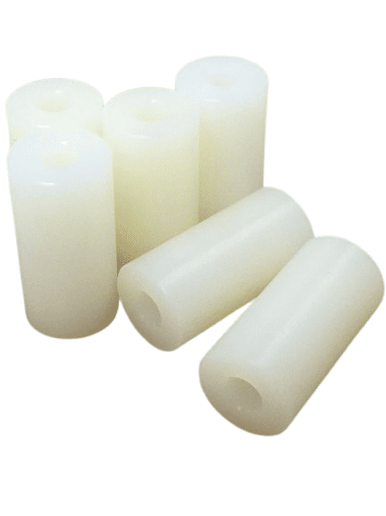 White cylindrical wax candles grouped together.